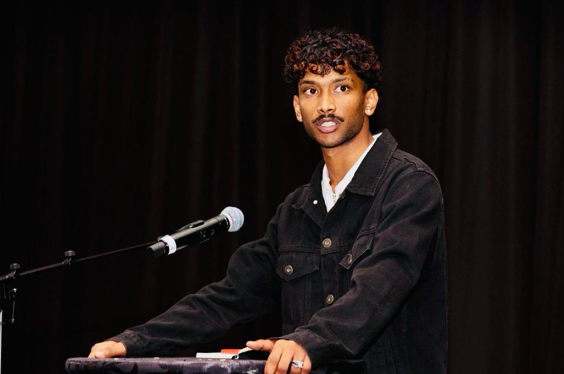 Sulai Nakooda speaking at a microphone